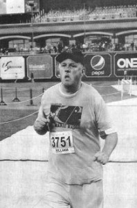 FE's Bill Blank, wearing a Free Marie t-shirt, crosses the finish line at the Indianapolis Half-Marathon