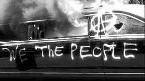 Nothing draws a crowd like a burning limousine. This one torched by demonstrators during the protests at the Trump inauguration, Jan. 20.
