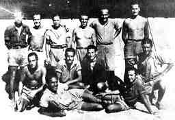 Photo of exiled Spanish anarchists in the concentration camp at Barcarès, France, August 1939. Left to right: Diego Camacho, J. Alfonso, Federico Arcos, Salvador Sarrau, P. Rafles, T. Agustí. Seated: Paulino Casajuana, Agustín Roa, Liberto Sarrau, Raúl Carballeira. Reclining: Pedro Torralba, Germinal Gracia (Víctor García).