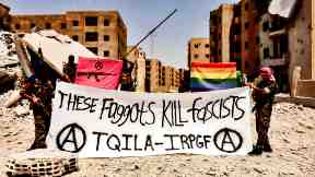 photo of antifa protesters; banner reads These faggots kill fascists