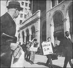 photo shows suited businessmen observing SDS protest, Detroit, April, 1968.