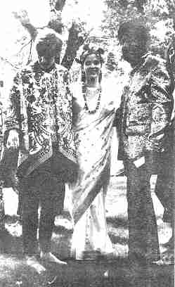 photo of Bridegroom Tom Nixon and Bride Kate Tomaino stand with Ali of Monkey Boutique