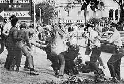 Photo shows multiple scuffles with police during an anti-war demo, Detroit, 1969
