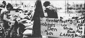 Photo shows racist slogans along with US troops abusing local people. Further description in text.