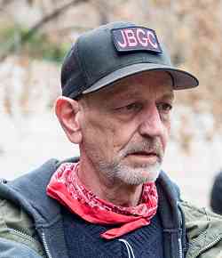 Portrait photo of Will Van Spronsen wearing a John Brown Gun Club cap