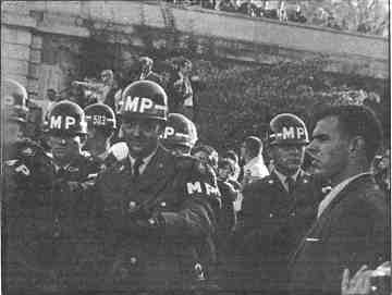 photo shows protesters peacefully confronting military police at the Pentagon.