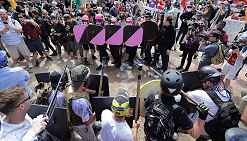 Photo shows protesters, some bearing black and pink shields.