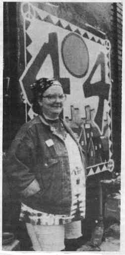 A photo showing a smiling Carla Glidden standing in front of the 404 Space in Detroit