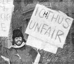 Photo shows Ted Lucas with sign reading "Ichthus Unfair"