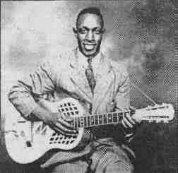 A photo of Peetie Wheatstraw playing guitar
