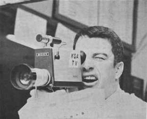 a photo depicts a man appearing to operate a TV camera.