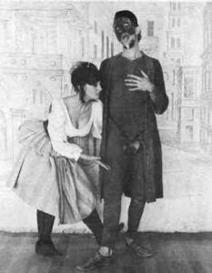Photo shows a scene from L'Amant Militaire. A young woman shows affection for the inert figure of her martial lover.