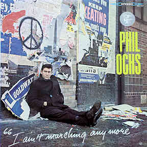 Color image of album cover for Phil Ochs' 1966 LP "I ain't Marchin' Any More." Photo shows Ochs sitting on the ground next to a wall totally covered with anti-war posters and a peace sign.