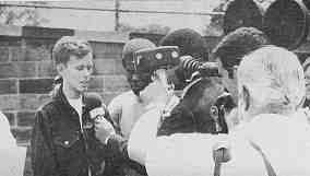 A photo shows Spec 4 Jerry Brown being filmed and interviewed by media. Credit: Mike John