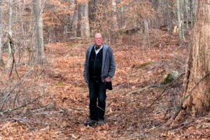 Photo of James C. Scott standing in a wooded setting